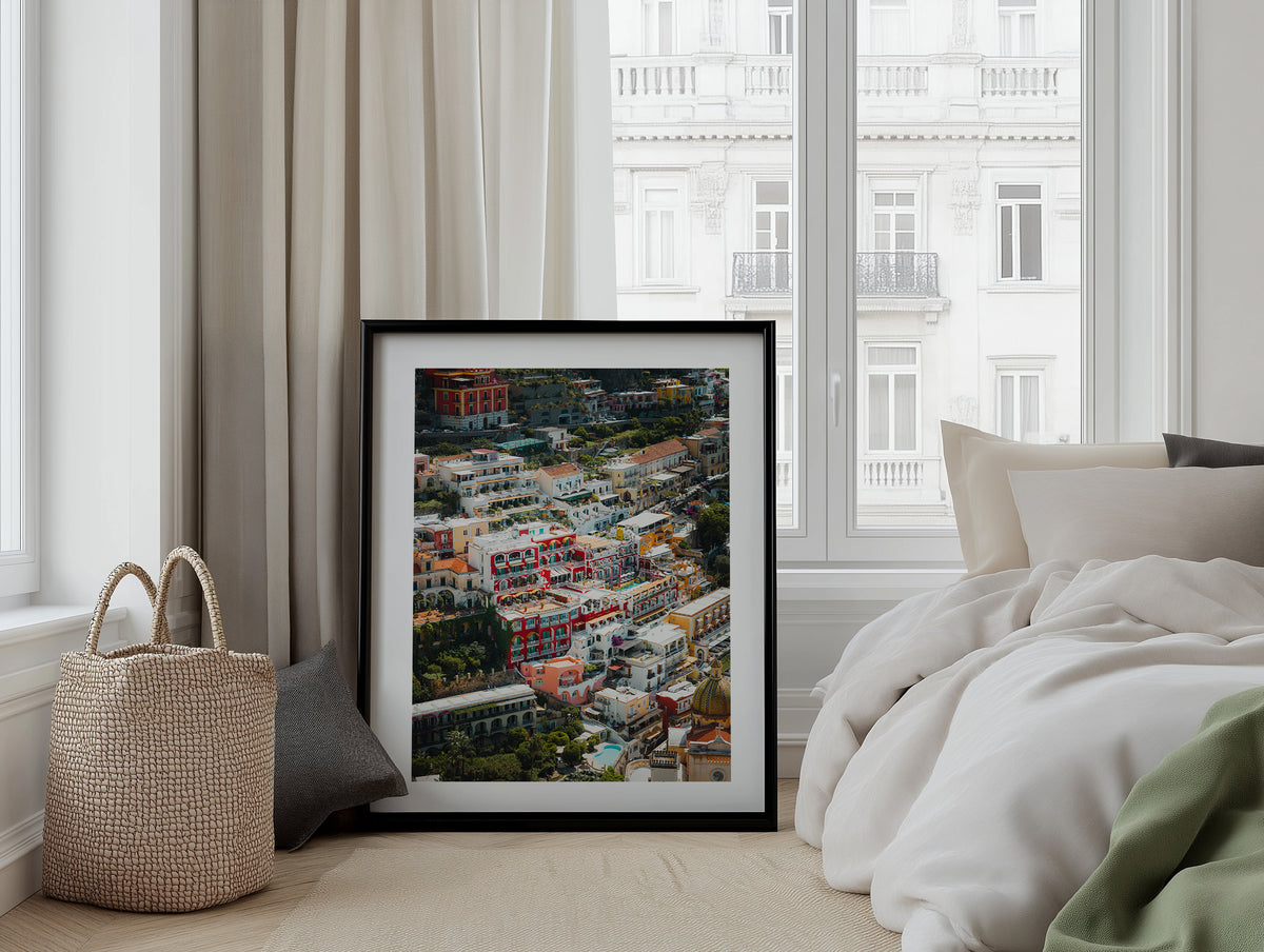 Colour aerial view of Positano residences framed artwork displayed on a room wall
